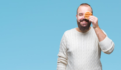 Young caucasian hipster man eating sweet waffle over isolated background with a happy face standing and smiling with a confident smile showing teeth