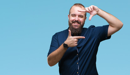 Fototapeta premium Young caucasian hipster man over isolated background smiling making frame with hands and fingers with happy face. Creativity and photography concept.