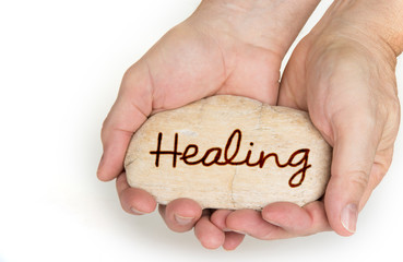 Pebble stone in hands. Concept for  healing sign