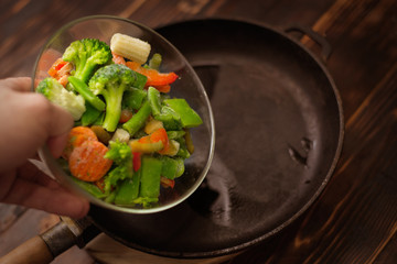 A mixture of fresh-frozen vegetables poured into the pan.