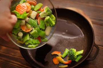 A mixture of fresh-frozen vegetables poured into the pan.