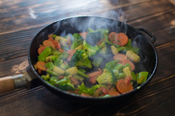 Fry, cook different vegetables in a pan.