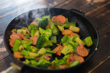 Fry, cook different vegetables in a pan.