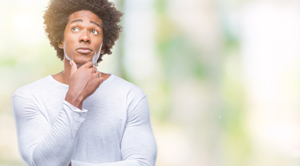 Afro american man over isolated background with hand on chin thinking about question, pensive expression. Smiling with thoughtful face. Doubt concept.