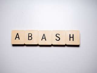 Abash word made with blocks on white table. Top view