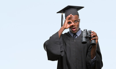 Young graduated african american man looking for a job using binoculars with happy face smiling doing ok sign with hand on eye looking through fingers