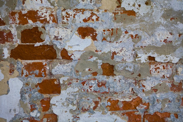 Old shabby brick wall of the monastery close-up.
