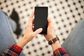 Woman with modern mobile phone in hands