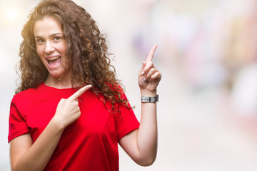 Beautiful brunette curly hair young girl wearing casual look over isolated background smiling and looking at the camera pointing with two hands and fingers to the side.