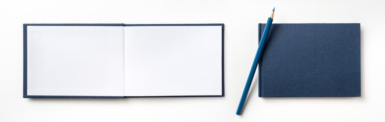 Top view of blue hardcover notebook and pencil