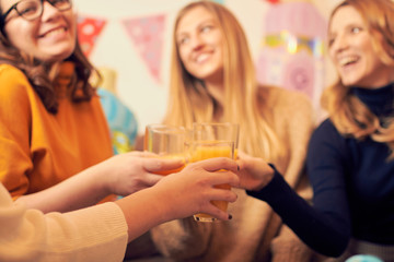 Pregnant woman celebrating baby shower party with friends.