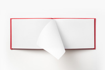 Top view of red notebook with open page