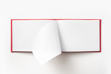 Top view of red notebook with open page