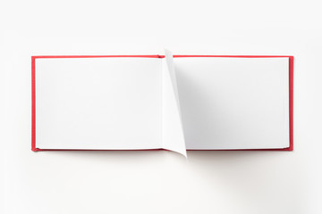 Top view of red notebook with open page