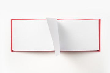 Top view of red notebook with open page