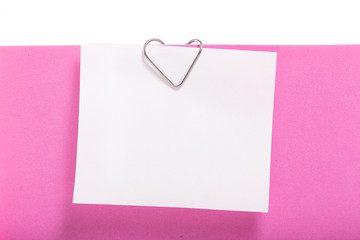 Empty sheet of paper on a clip in the form of a heart.