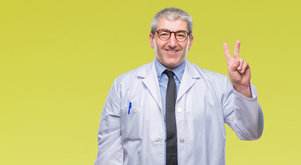 Handsome senior doctor, scientist professional man wearing white coat over isolated background showing and pointing up with fingers number two while smiling confident and happy.