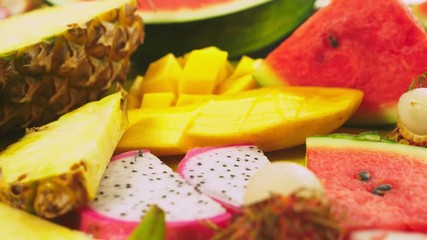 Mixed tropical fruits, closeup. fresh fruit sliced. background.
