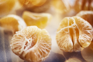 ripe tangerine slices brightly lit on a blurred background