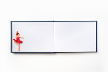 Top view of red hardcover notebook and toy