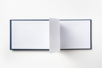 Top view of blue notebook with open page