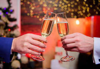 Male hands formal suit hold champagne glasses. Cheers concept. New year corporate party. Party with champagne. Lets celebrate. Successful year. Drink champagne at party. Colleagues celebrate new year