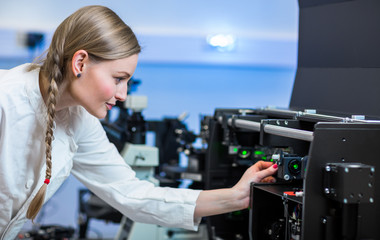 Female researcher carrying out research in a chemistry lab (color toned image; shallow DOF)