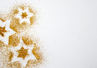 Stars glitter pattern gold and white background. Abstract bright golden design for wallpaper, Christmas decoration. Symbol of holiday