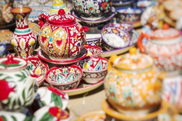 Fototapeta na wymiar Plates and pots on a street market in Uzbekistan. Selective Focus.