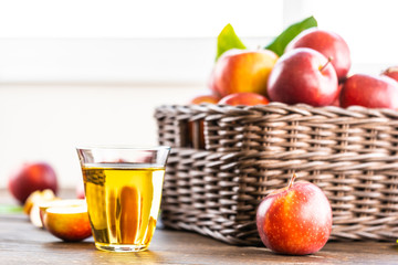 Apples juice in glass with apple in the basket