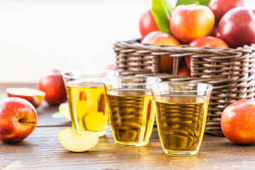 Apples juice in glass with apple in the basket