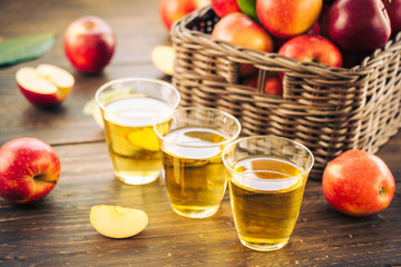 Apples juice in glass with apple in the basket