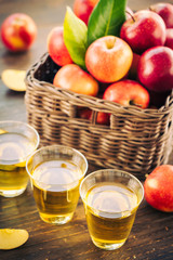 Apples juice in glass with apple in the basket