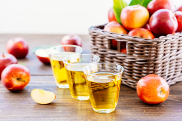 Apples juice in glass with apple in the basket