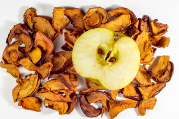 Dried apples and fresh apple on white background