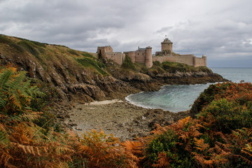 Fototapeta na wymiar The famous medieval stone castle - fortress la Latte in the fall during a storm on the Celtic Sea in Normandy, France