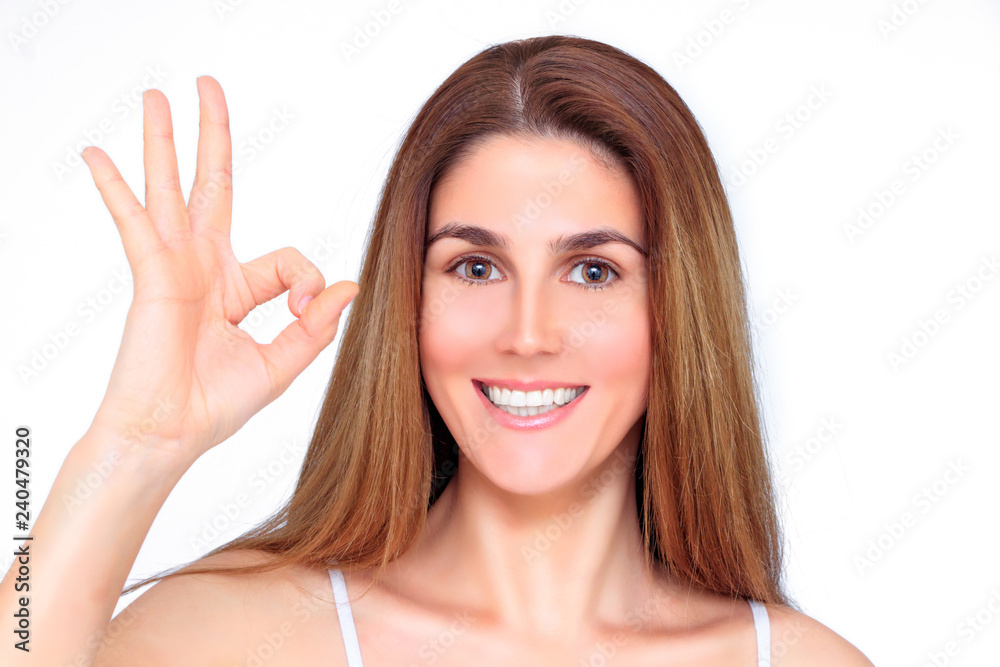 Wall mural beautiful laughing woman shows everything ok with her hand