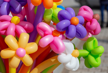 Multicolored flowers from balloons as background