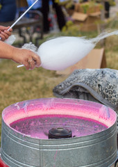 Cooking cotton candy on a city street