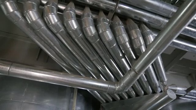 Stainless steel ventilation tubes fixed to ceiling on an oil producing factory 