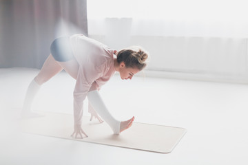 Young woman standing in Pyramid pose