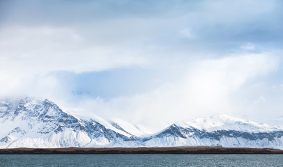 Coastal landscape with snowy mountains