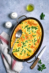 Frittata with potato, cheese and green pea .Top view.