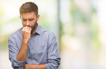 Adult hispanic man over isolated background looking stressed and nervous with hands on mouth biting nails. Anxiety problem.