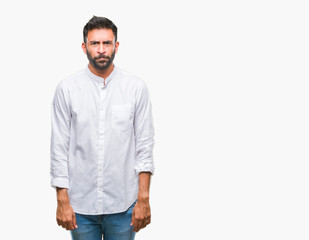 Adult hispanic man over isolated background skeptic and nervous, frowning upset because of problem....