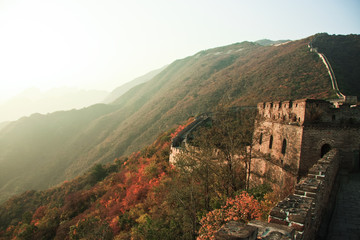 Fototapeta na wymiar Towers of a great wall at sunset in autumn