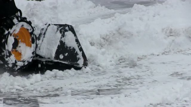 Street cleaning the city from snow in the winter with the help of special equipment vehicle