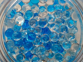 Scented beads, semitransparent white and blue aroma balls, top macro view of freshener fragrance...