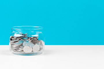 Business concept, saving planning with coins in glass jar