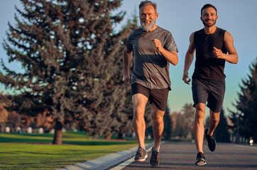 The father and son running on the road